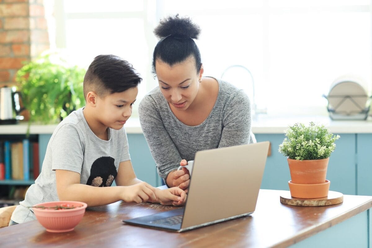 Mom and son creating strong passwords on a laptop computer