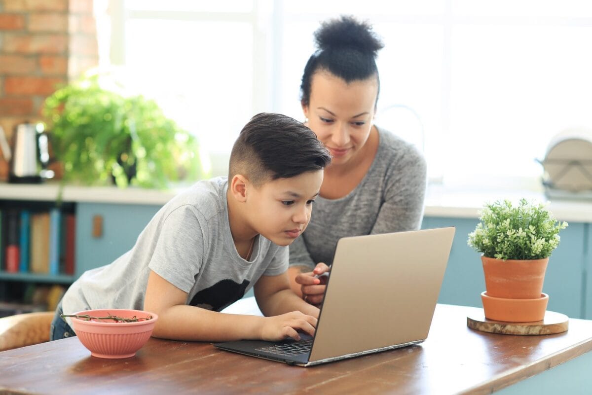Mom and son creating strong passwords on a laptop computer